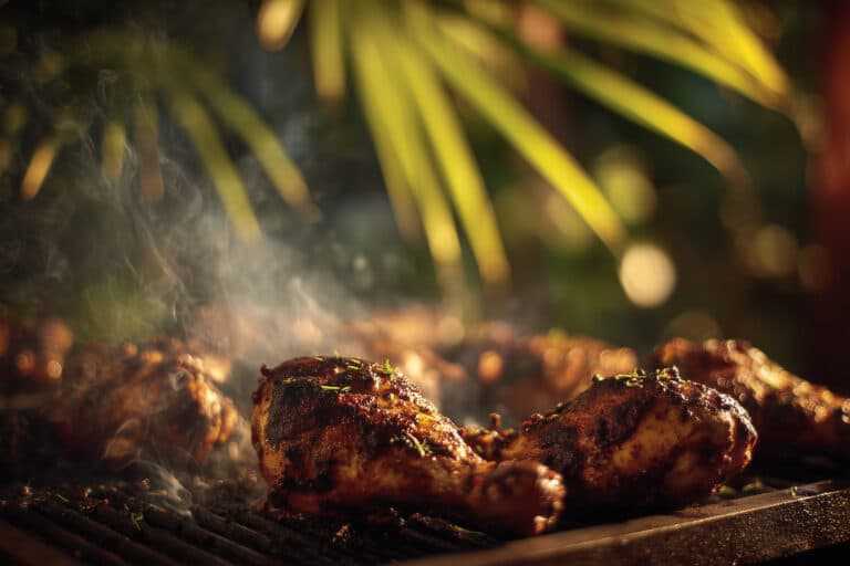 Jerk chicken smoky grill char perfection showing Jamaican chicken with authentic barbecue marks and cooking atmosphere